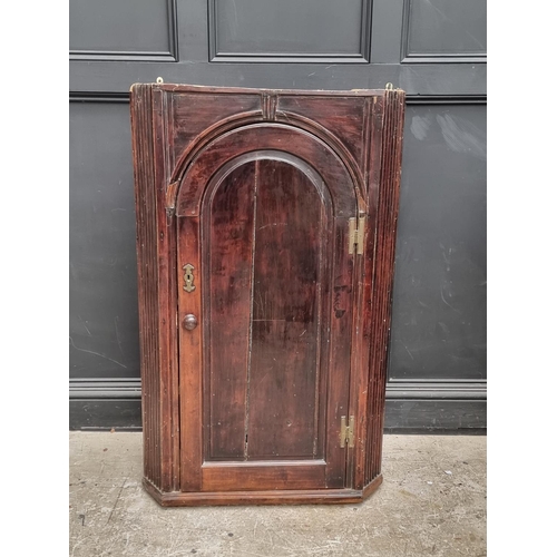 1100 - An 18th century fruitwood hanging corner cupboard, 122.5cm high x 75.5cm wide.