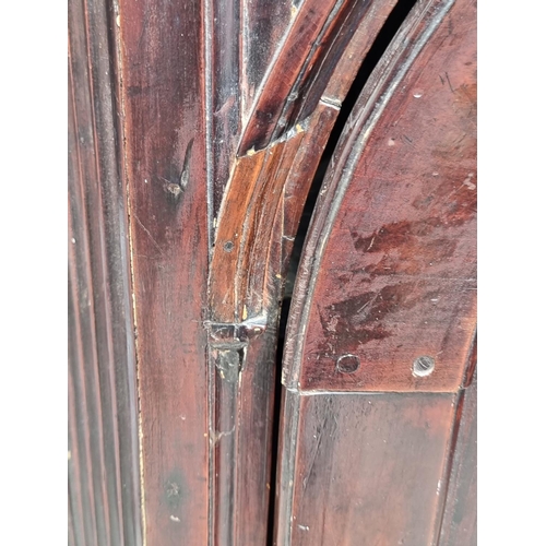 1100 - An 18th century fruitwood hanging corner cupboard, 122.5cm high x 75.5cm wide.