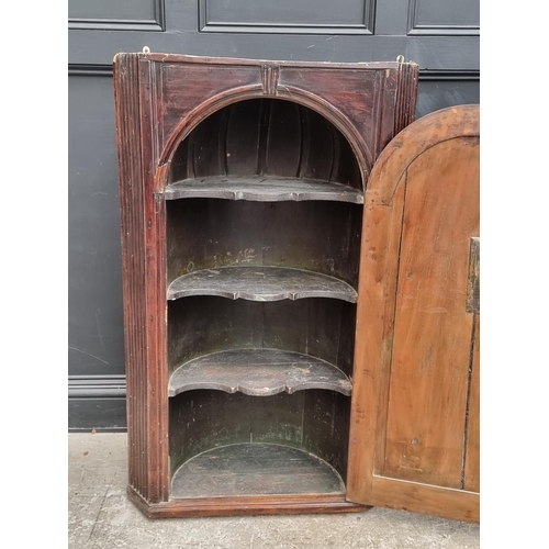 1100 - An 18th century fruitwood hanging corner cupboard, 122.5cm high x 75.5cm wide.