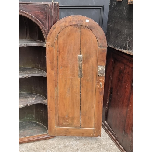 1100 - An 18th century fruitwood hanging corner cupboard, 122.5cm high x 75.5cm wide.