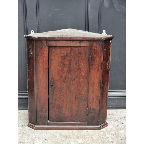 1101 - An 18th century solid yew hanging corner cupboard, 85.5cm high x 77cm wide.