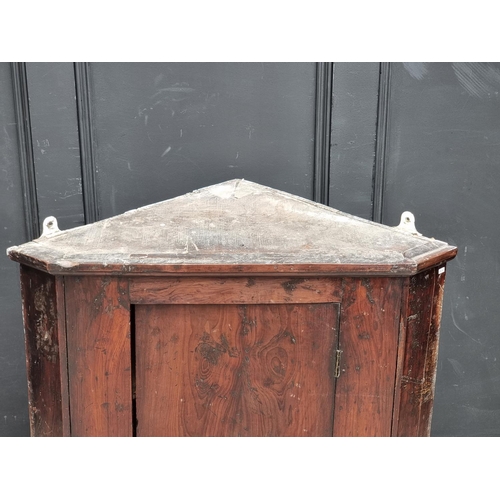 1101 - An 18th century solid yew hanging corner cupboard, 85.5cm high x 77cm wide.