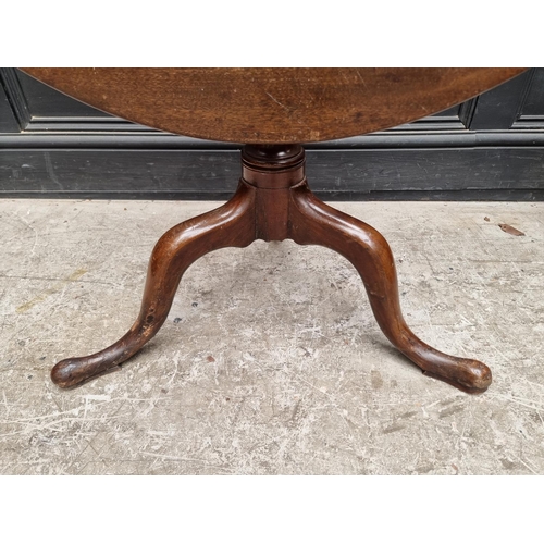 1109 - A George III mahogany tilt-top tripod table, 86cm diameter.