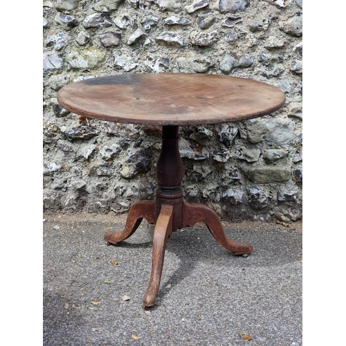 1110 - A George III mahogany tilt-top tripod table, 84cm diameter.