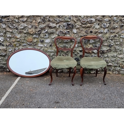 1112 - A pair of Victorian rosewood dining chairs; together with an Edwardian mahogany oval mirror, 89 x 60... 