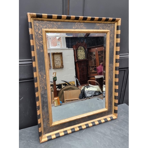 1120 - A gilt and ebonised frame rectangular wall mirror, 79.5 x 64.5cm.