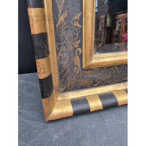 1120 - A gilt and ebonised frame rectangular wall mirror, 79.5 x 64.5cm.