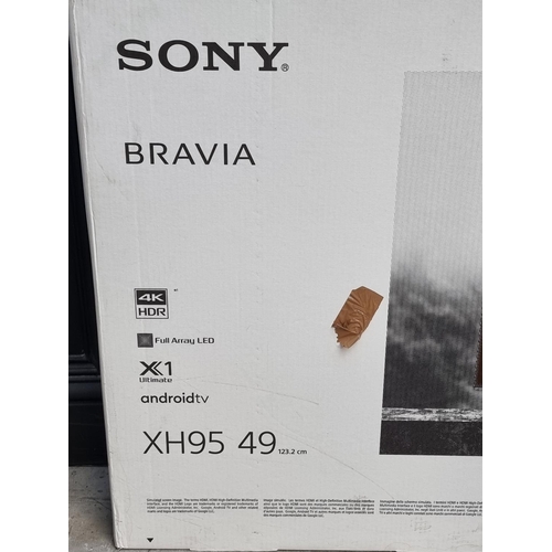 1162 - A Sony XH95 49in television, with stand and remote control, boxed.