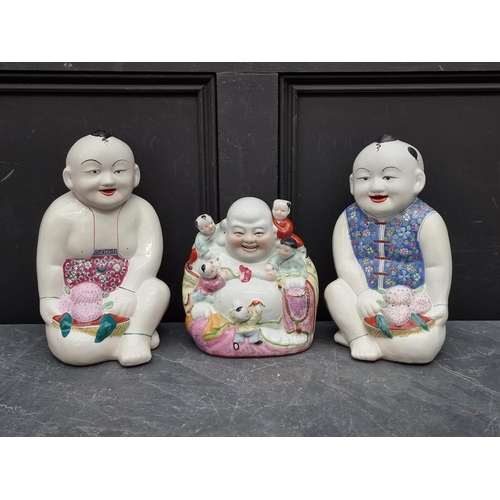 1167 - A Chinese famille rose Buddha and boys figure group, 22cm high; together with a larger pair of seate... 