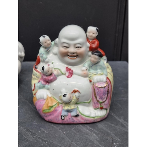 1167 - A Chinese famille rose Buddha and boys figure group, 22cm high; together with a larger pair of seate... 