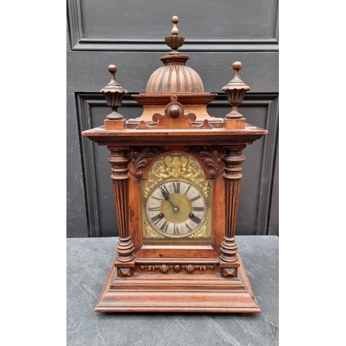 1197 - An early 20th century German HAC walnut mantel clock, 52cm high, with pendulum.... 