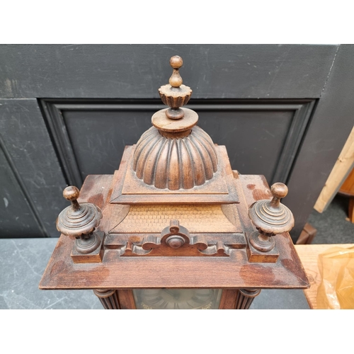 1197 - An early 20th century German HAC walnut mantel clock, 52cm high, with pendulum.... 