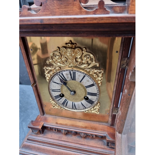 1197 - An early 20th century German HAC walnut mantel clock, 52cm high, with pendulum.... 