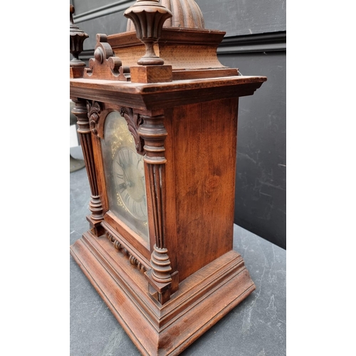 1197 - An early 20th century German HAC walnut mantel clock, 52cm high, with pendulum.... 