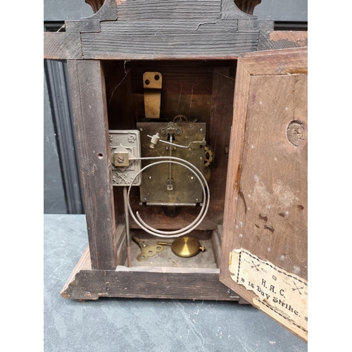 1197 - An early 20th century German HAC walnut mantel clock, 52cm high, with pendulum.... 