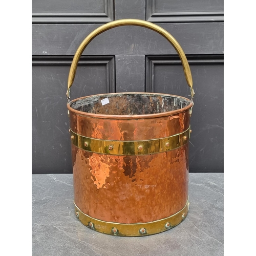 1202 - An old copper and brass bound swing handled bucket, 50cm high x 31.5cm diameter.