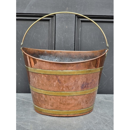 1203 - A Georgian copper and brass swing handled oval bucket, 36.5cm wide.