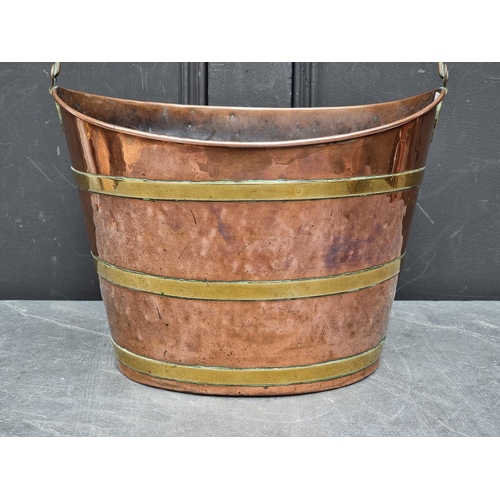 1203 - A Georgian copper and brass swing handled oval bucket, 36.5cm wide.