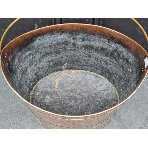 1203 - A Georgian copper and brass swing handled oval bucket, 36.5cm wide.