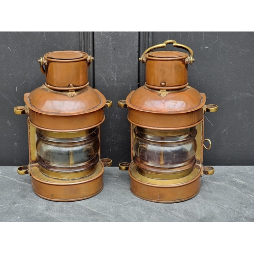 1204 - A pair of antique copper and brass ship's lanterns, 24cm high.