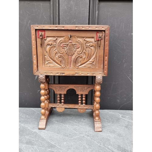 1210 - A novelty carved walnut jewellery box, 29cm high x 21.5cm wide.