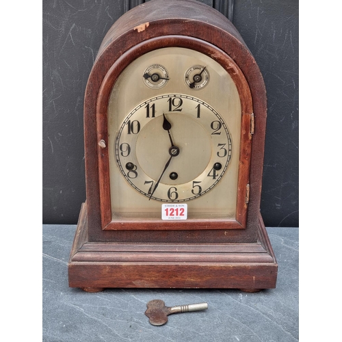 1212 - An early 20th century mahogany dome top mantel clock, 34.5cm high, with pendulum.... 