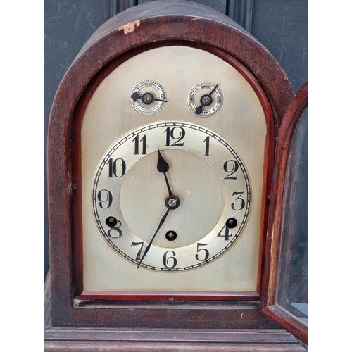 1212 - An early 20th century mahogany dome top mantel clock, 34.5cm high, with pendulum.... 