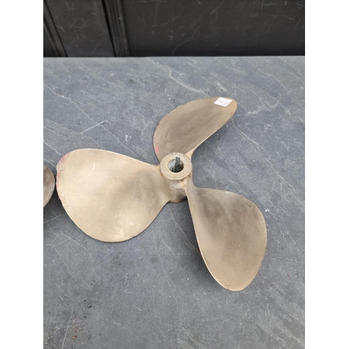 1223 - A bronze propeller, 29.5cm diameter; together with a similar smaller brass example. (2)... 