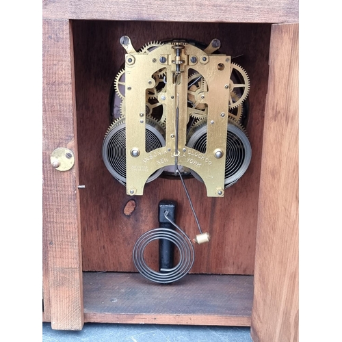 1231 - Two early 20th century oak mantel clocks, largest 36cm high, (largest lacking pendulum).... 