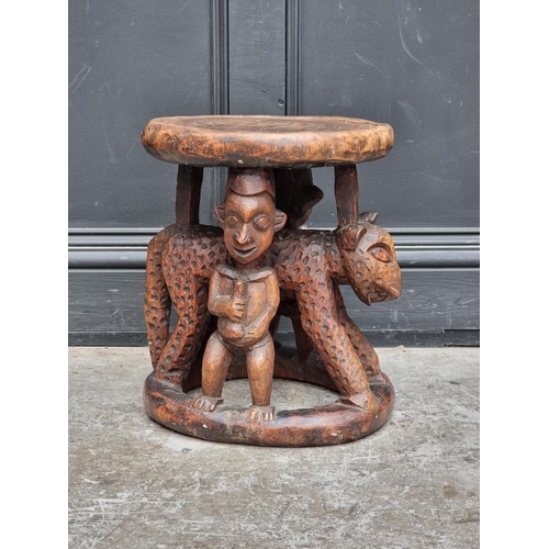 1348 - Ethnographica: an African tribal carved wood stool, possibly Yoruba, 41cm high.