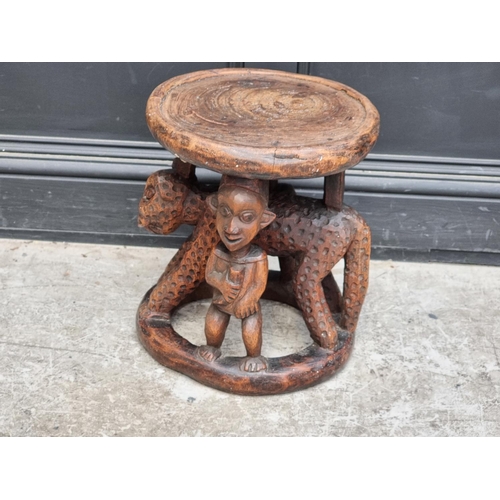 1348 - Ethnographica: an African tribal carved wood stool, possibly Yoruba, 41cm high.