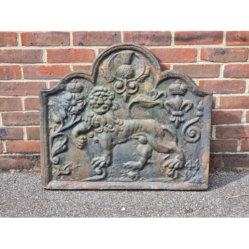 1349 - An antique cast iron fireback, decorated with a lion, 68 x 77cm.