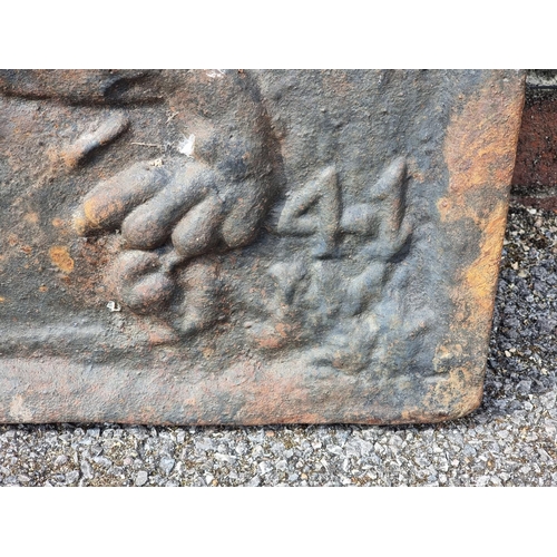 1349 - An antique cast iron fireback, decorated with a lion, 68 x 77cm.