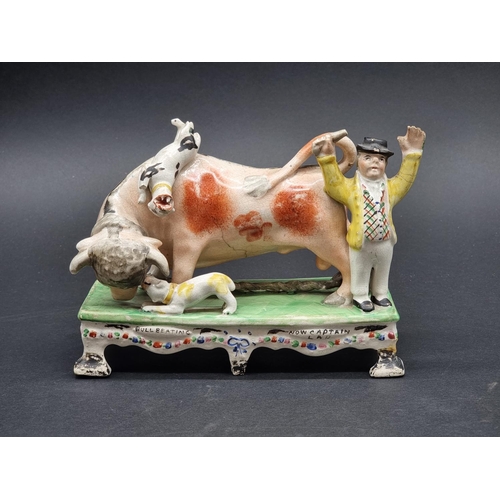 1352 - An early 19th century Pearlware 'Bull Baiting' figure group, by Obadiah Sherratt, 18.5cm wide.... 