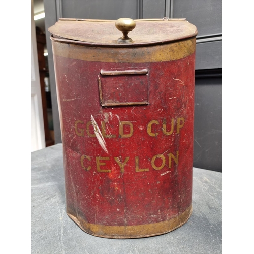 1375 - A large antique red and gilt toleware 'Gold Cup, Ceylon' tea canister, 50cm high.... 