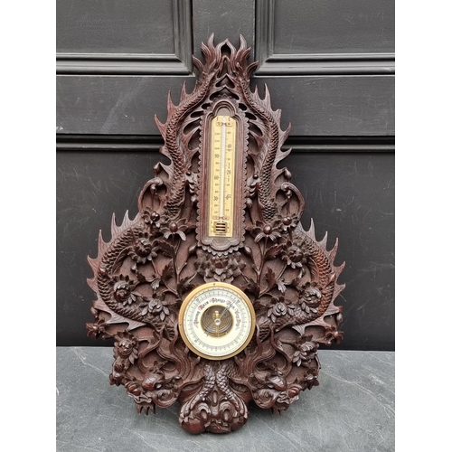 1376 - A Chinese carved hardwood framed aneroid barometer, 59cm high.