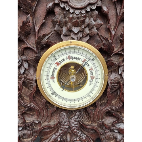 1376 - A Chinese carved hardwood framed aneroid barometer, 59cm high.