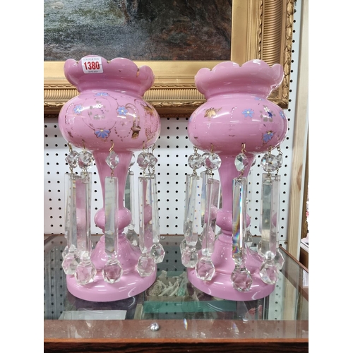 1380 - A pair of Victorian pink glass lustres, 38cm high.