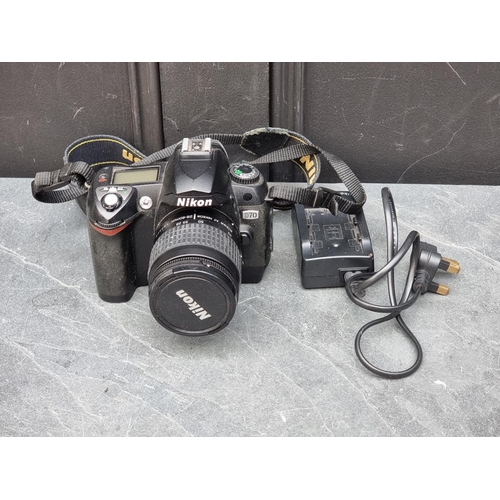 1384 - Cameras: a Nikon D70, with 28-80mm 1:3.3/5.6 G lens, with cap and Nikon battery charger.... 