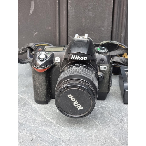 1384 - Cameras: a Nikon D70, with 28-80mm 1:3.3/5.6 G lens, with cap and Nikon battery charger.... 