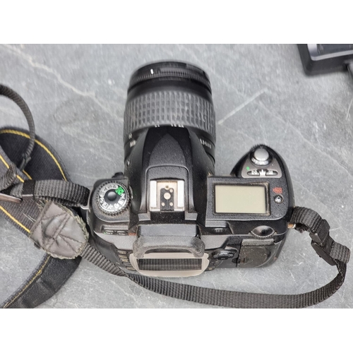 1384 - Cameras: a Nikon D70, with 28-80mm 1:3.3/5.6 G lens, with cap and Nikon battery charger.... 