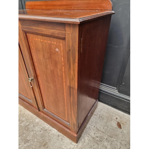 1009 - An Edwardian mahogany and satinwood chest of drawers, 84cm wide; together with a similar cupboard, 7... 