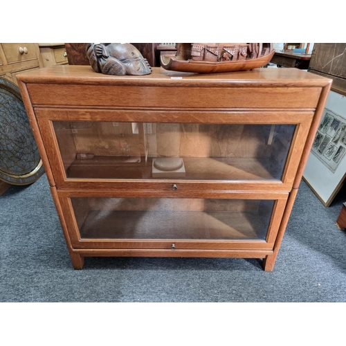 1063 - A Globe Wernicke style oak two-tier sectional bookcase, 87cm wide.