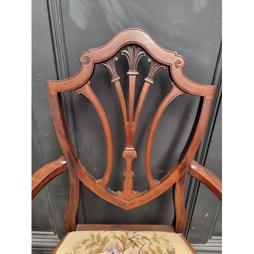 1084 - A late Victorian carved mahogany dining chair; together with another early 20th century mahogany elb... 