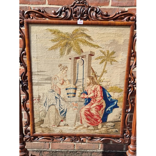 1092 - A large Victorian carved walnut and tapestry panelled fire screen, 132.5cm high x 85.5cm wide.... 