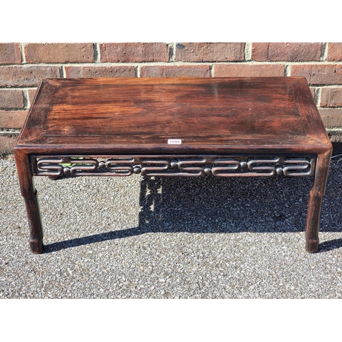 1094 - A Chinese hardwood rectangular low occasional table, 77cm wide, (losses to one section of friez... 