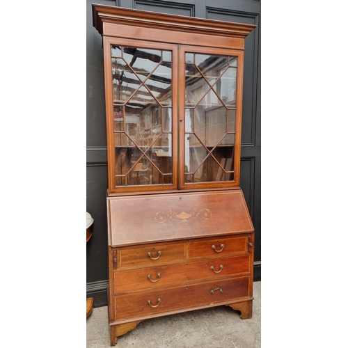 1097 - An Edwardian mahogany and inlaid bureau bookcase, 116cm wide.