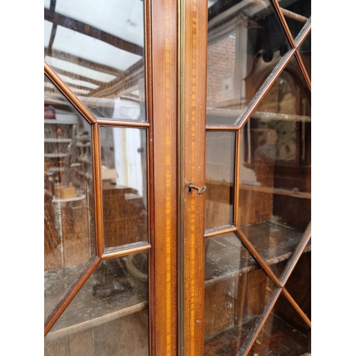 1097 - An Edwardian mahogany and inlaid bureau bookcase, 116cm wide.