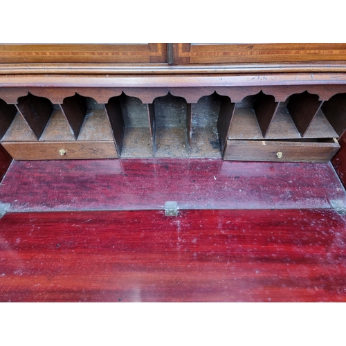 1097 - An Edwardian mahogany and inlaid bureau bookcase, 116cm wide.