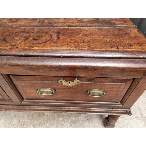 1098 - An 18th century oak two drawer side table, 131cm wide, (alterations).